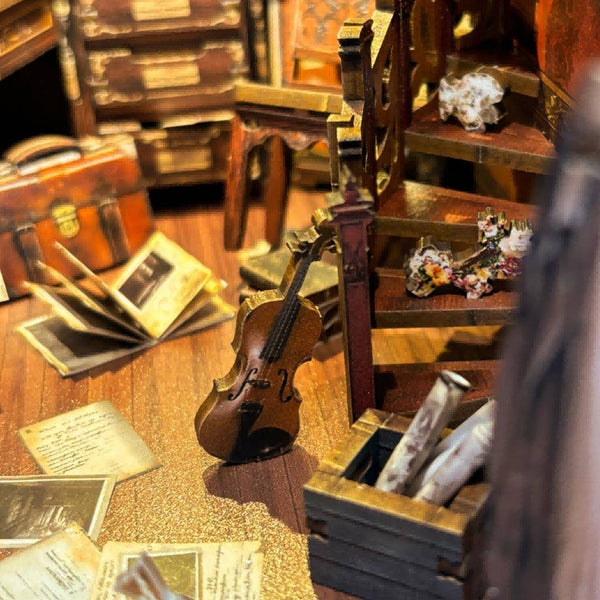 image displaying the essentials of the detective in Bell's Mystery DIY Book Nook Shelf Insert, including miniature briefcase, books, files and violin