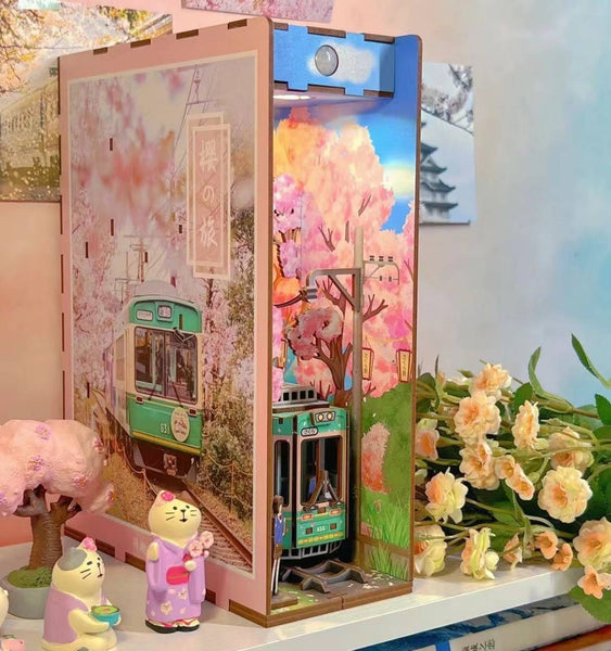 Japanese Sakura Densya DIY Book Nook Kit, A charming miniature 3d wooden puzzles the captures the essence of springtime in Japan, perfect for bookshelf decor or a delightful gift for Japanese culture lovers. Dust Cover